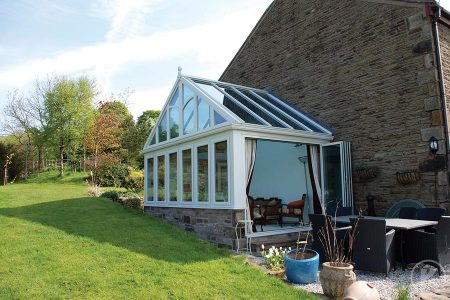 New conservatory with white uPVC roof and brick structure